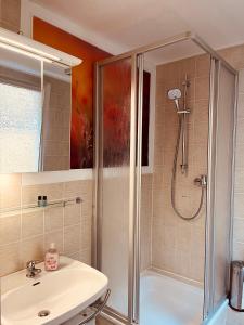 a bathroom with a shower and a sink at Meyver Cochem Centrum. in Cochem