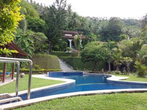 a swimming pool in the yard of a house at Sunset Villa in Senggigi