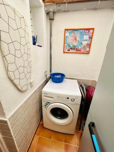 a washer and dryer in a small bathroom at Sun Dream Bungalow in San Bartolomé
