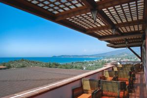 a balcony with chairs and a view of the ocean at Kallisti Hotel in Potos