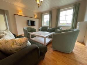 a living room with a couch and chairs and a table at Landgut in Vetschau