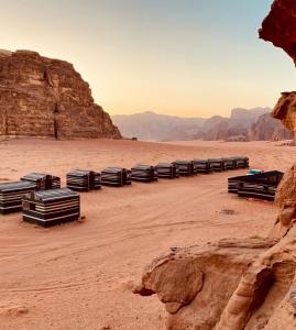 a row of black containers in the desert at Wadi Rum Jordan Camp in Wadi Rum