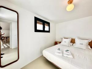 a bedroom with a mirror and a bed at Peral Old Town Penthouse II - EaW Homes in Marbella