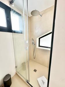 a shower with a glass door in a bathroom at Peral Old Town Penthouse II - EaW Homes in Marbella