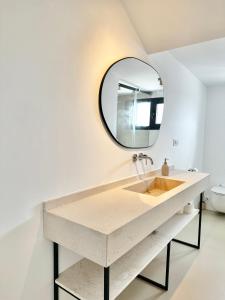 a bathroom with a sink and a mirror at Peral Old Town Penthouse II - EaW Homes in Marbella