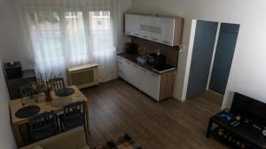 an overhead view of a kitchen with a table and a dining room at H22 Apartman in Eger