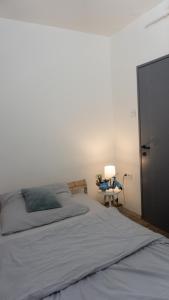 a bedroom with a bed and a desk with a lamp at H22 Apartman in Eger
