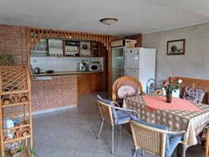 a kitchen and dining room with a table and a refrigerator at Guest House Benita in Devin