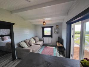 a living room with a couch and a table at Blue Haven Lodge in Doolin