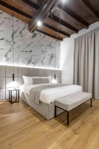 sypialnia z dużym łóżkiem i marmurową ścianą w obiekcie Home at Rome Luxury Navona w Rzymie