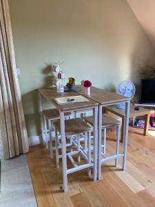 a dining room table with stools and a table at Scarr View 1st floor Apartment A98W710 in Wicklow