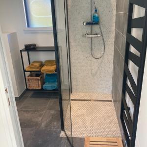a walk in shower with a glass shower backdoor at Ker Neizh Cancale, Cottage Baie de Cancale GR34 in Cancale