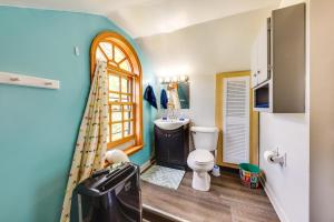 a bathroom with a toilet and a sink and a window at Waterfront Fox Lake Vacation Rental with Fire Pit! in Fox Lake +28 photos