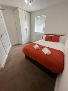 a bedroom with a large bed with two towels on it at Hartington House in Middlesbrough