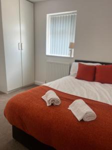 a bedroom with two white towels on a bed at Hartington House in Middlesbrough