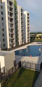 a swimming pool in front of two tall buildings at Apartamento vacacional in Girardot