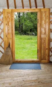 a window in a room with a broom at La Yourte du Masfranc in Latour-de-Carol +5 photos