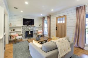 a living room with a couch and a fireplace at Pecan Blue Frisco Home with Private Yard and Hot Tub in Frisco