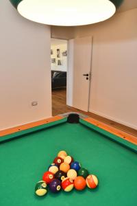 a pool table with a bunch of balls on it at Luxury Villa Vela Baraka with Heated Pool in Dragove