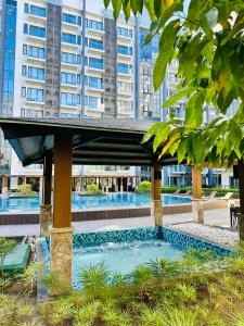 a swimming pool in front of a building at 81 Newport Condominium Cluster 5 3A by Rechelle Nunag in Manila