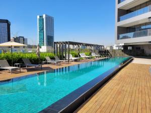 a swimming pool on the roof of a building at Jockey Club Residence in Sao Paulo