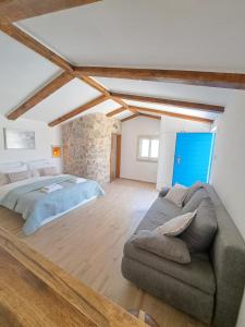 a bedroom with a bed and a couch in it at Danino in Jezera +75 photos