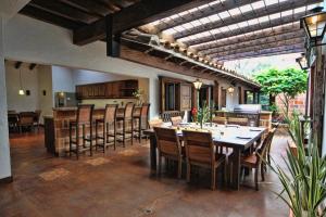 a large dining room with a table and chairs at Casa Del Reloj in Medellín
