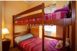 two bunk beds in a room with a lamp at Casa Vacacional Vigo Planta Baja in Vigo