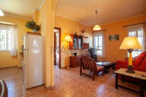 - un salon avec un canapé rouge et un réfrigérateur dans l'établissement Casa Vacacional Vigo Planta Baja, à Vigo