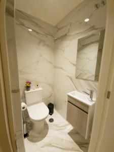 a white bathroom with a toilet and a sink at RAIO FLAT in Braga