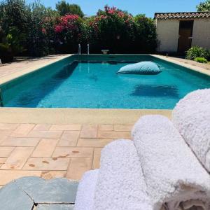 a swimming pool with a pillow in the middle of it at Villa Mon Rêve in Le Cannet