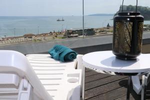 a table and chairs on a balcony with a view of the ocean at Riviera Apartments - Five Stylish Penthouse Apartments with Unrivalled Sea Views of Teignmouth, Shaldon, The Jurassic Coastline & The Teign Estuary in Teignmouth
