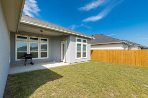 a house with a fence in a yard at Luxurious 4-Bedroom Retreat Near the Beach: King Suite, High-Speed WiFi, Free Parking in Corpus Christi