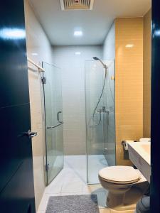 a bathroom with a shower and a toilet and a sink at 81 Newport Condominium Cluster 5 3A by Rechelle Nunag in Manila