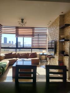 a living room with a couch and a table at Superb 2 Bed in middle of Amman in Amman