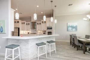 a kitchen and dining room with a table and chairs at Luxurious 4-Bedroom Retreat Near the Beach: King Suite, High-Speed WiFi, Free Parking in Corpus Christi