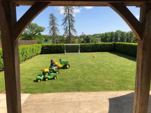 a group of toy tractors on a lawn at Moo Cow Cottage Self Catering in Oakham +29 photos