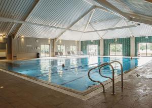 a large indoor swimming pool with an open ceiling at The Essex Golf And Country Club 