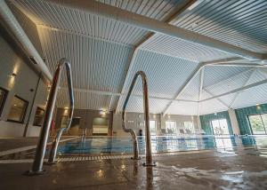 an empty swimming pool with a large ceiling at The Essex Golf And Country Club 