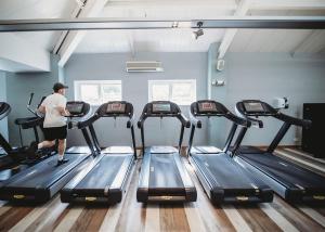 a man walking on a treadmill in a gym at The Essex Golf And Country Club 