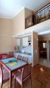 a kitchen and dining room with a table and chairs at Nossa Casa in Bečići +38 photos