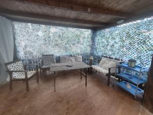 a room with a table and chairs and a wall of glass at La Sorgente Appartamento con piscina privata in Calice Ligure