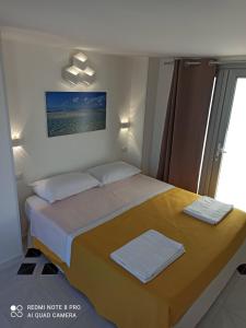 a bedroom with a bed with two towels on it at Mare D'amare in Porto Cesareo