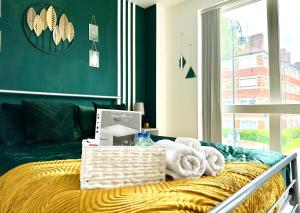 a bedroom with a bed with a green wall at Comfortable Private Room in Bermondsey in London