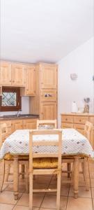a kitchen with wooden cabinets and a table with a bench at villa smeralda in Cannigione
