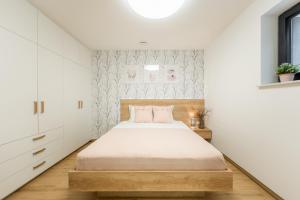 a bedroom with a bed and white walls at Apartments Gros in Radeče