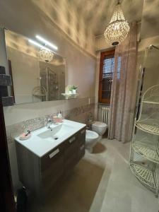 a bathroom with a sink and a toilet and a mirror at Sopra Le Poste in Arezzo