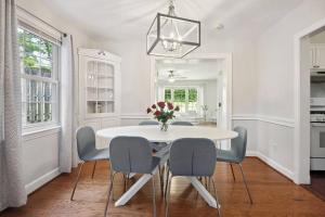 a white dining room with a white table and chairs at Arlington Colonial Oasis: 15-Minute Drive to Washington DC in Arlington