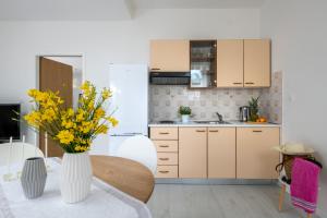 uma cozinha com uma mesa com flores amarelas num vaso em Apartment Alex em Labin