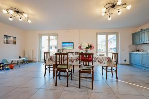 a dining room with a table and chairs in a room at Discover Tortoreto in Tortoreto Lido